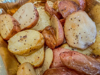 Sliced, roasted, red-skinned potatoes with spices