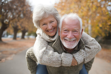 Senior man giving woman piggyback ride