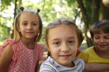 Cute little kids taking selfie in park, selective focus