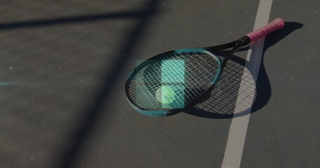 Lying overlapping two tennis rackets with tennis ball on hardcourt near boundary line, copy space