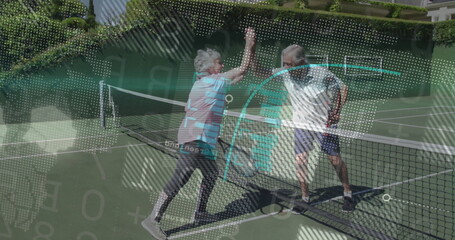Celebrating senior tennis couple exchanging high-five in sportswear on court, with rackets and net