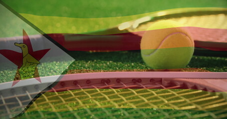 Showing tennis racket and yellow ball lying on green synthetic court, with Zimbabwe flag overlay