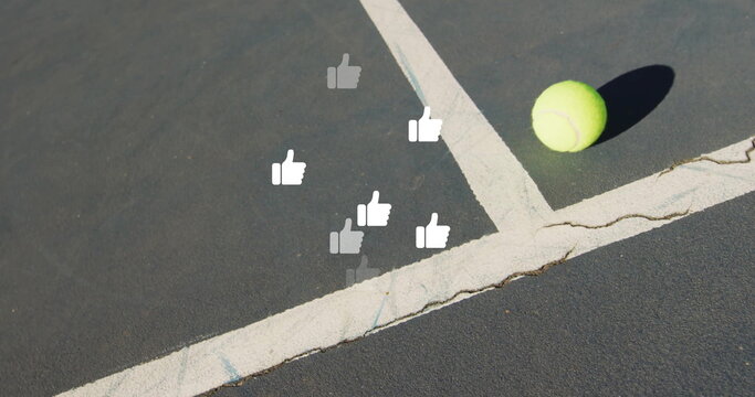 Fototapeta Lying tennis ball near white lines on outdoor hard court, floating thumbs-up icons, copy space