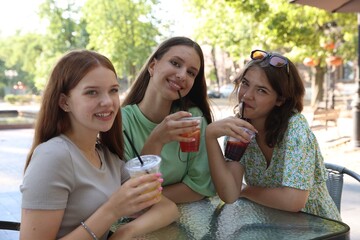 Friends enjoying refreshing drinks in outdoor cafe
