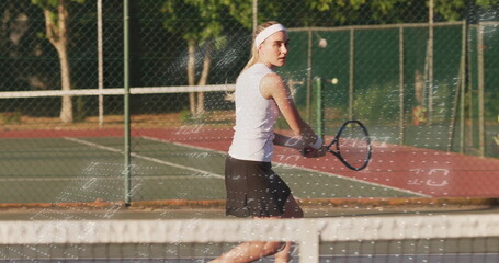 Female athlete wearing headband preparing backhand on tennis court behind net, with racket and ball © vectorfusionart