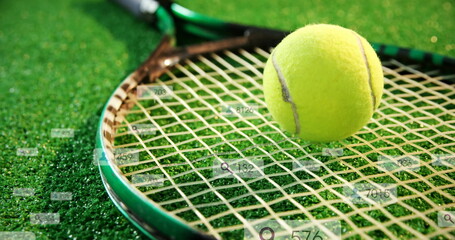 Highlighting tennis racket and ball lying on synthetic grass court, with digital overlay elements