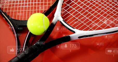 Displaying overlapping tennis rackets with yellow ball on red floor showing social media icons