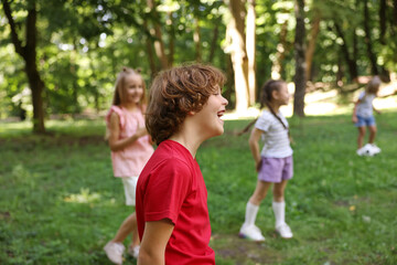 Fototapeta premium Cute little kids having fun together in park, selective focus