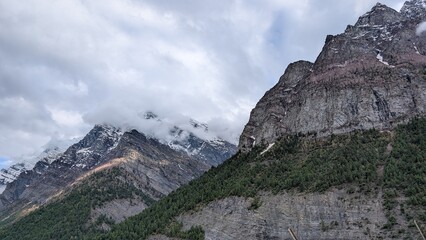 high mountain landscape with clouds covering a mountain