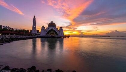 Fototapeta premium Sunrise over a mosque by the water