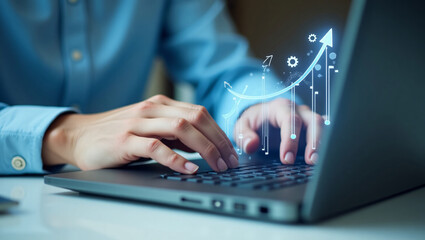 Obraz premium Hands typing on a laptop, with a glowing blue upward trending graph and gears, representing business growth or data analysis.