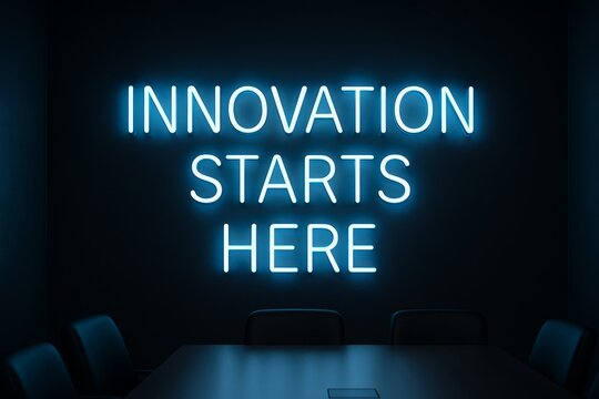 Innovation starts here neon sign above conference table, modern lab vibe