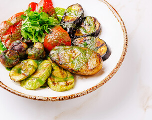 Colorful assortment of grilled vegetables served on a rustic plate