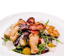 Fresh salad with grilled chicken, bacon, and cherry tomatoes served in a bowl