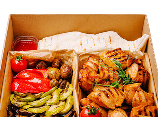 Grilled chicken platter with vegetables and sides from local eatery