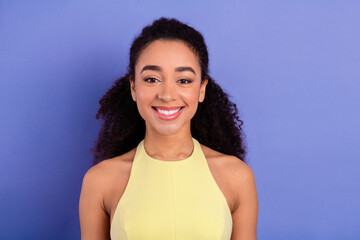 Portrait of a young woman in yellow dress with vibrant background and cheerful expression...