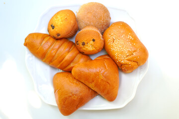 Breakfast Bakery items on White Plate – Isolated White Background.