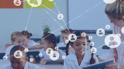 Teacher leaning over student guiding tablet use while education network nodes linking around class - Powered by Adobe