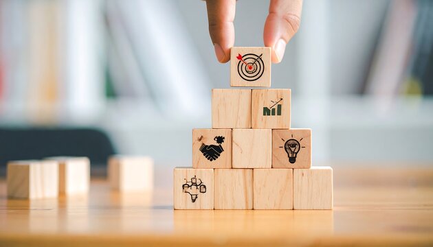 Wooden blocks stacked in a pyramid shape, each with a different business icon