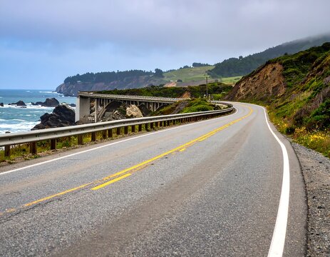 Coastal highway curves along a rugged cliffside - Powered by Adobe