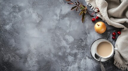 Gray textured background with cup of coffee and autumn leaves for seasonal warm mood
