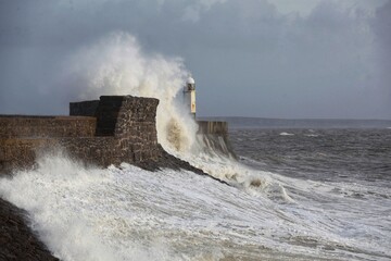 Giant waves hitting the sea wall and lighthouse at Porthcawl. © Paul
