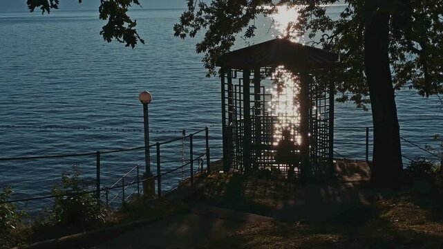Young attractive woman in bikini enjoying under gazebo by the sea in morning sun SlowMo