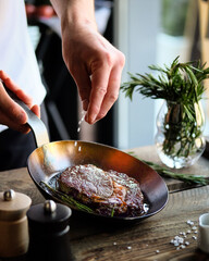 A Skilled Chef Seasoning and Preparing a Delicious Steak in