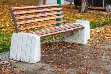 Old vintage bench, whose paintwork has worn out from atmospheric factors, worn off, exposing wooden...