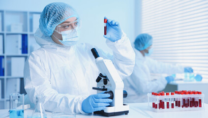 Medical analysis. Scientist working with blood sample in laboratory, selective focus