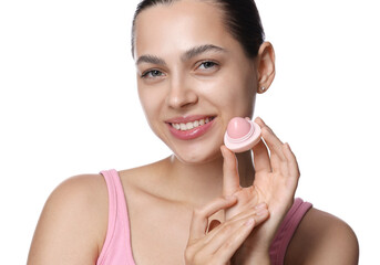 Young woman with lip balm on white background