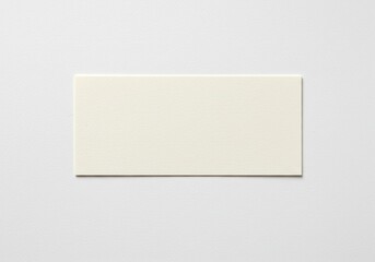 Fototapeta premium A blank rectangular offwhite paper card with a subtle texture, isolated on white background