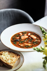 A delectable bowl of homemade tomato soup served with crusty