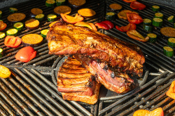 Grilled Pork Ribs And Vegetables On Barbecue. Summer Barbecue Scene With Juicy Pork Ribs And...