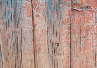 Weathered wooden planks with vibrant blue and orange hues create a rustic and artistic background...