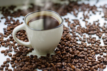 Coffee beans and a cup of black coffee. Food and drinks.
