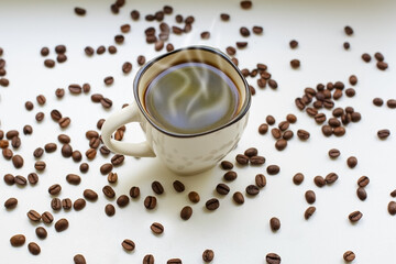 Coffee beans and a cup of black coffee. Food and drinks.