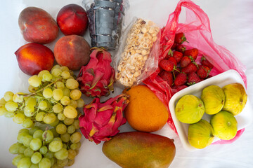 Assorted fresh fruits: peaches, grapes, dragon fruit and more