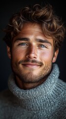 A close-up portrait of a smiling young man with curly hair wearing a cozy turtleneck sweater, showcasing warmth and confidence in his striking blue eyes.