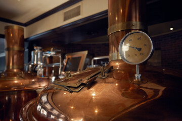 Copper brewery with thermometer in a brewery setting