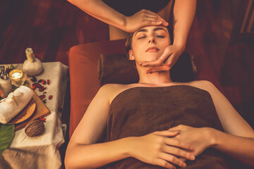 Caucasian woman enjoying relaxing anti-stress head massage and pampering facial beauty skin...