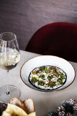 An Elegant Dish Presentation Accompanied by Wine and Bread for