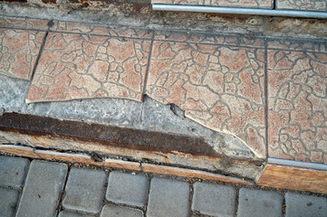 Broken tiled front porch stairs, damaged steps need repair