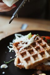 Homemade waffles with cheese and vegetables for breakfast.