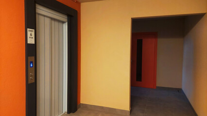 Elevator entrance at sixth floor in modern building corridor during daytime with minimalistic design