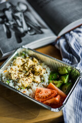 Healthy meal prep with chicken, vegetables and grains in plastic containers.