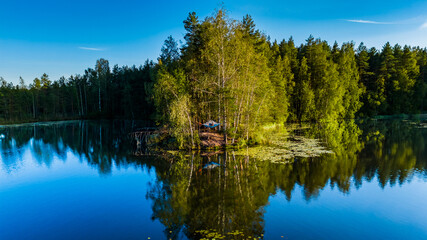 Hanging Tent Over Lakeshore with Perfect Forest Reflection, Finland, Summer Camping Adventure