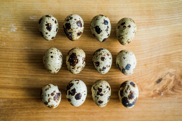 Fresh raw quail eggs on wooden table.