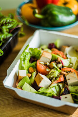 Healthy vegetable salad with tomatoes, peppers, cucumbers, onion and cheese.