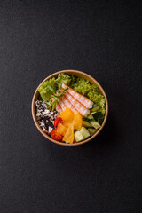 Bowl with shrimps, seafood, rice, oranges, tomatoes with sauce. Bowl with prawns